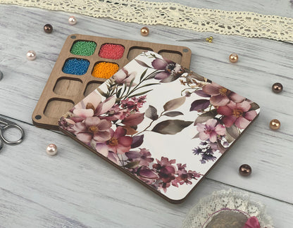 a table topped with crafting supplies next to a cup of coffee