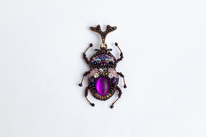 a close up of a bug on a white surface