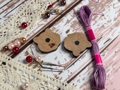 a pair of wooden buttons sitting on top of a table