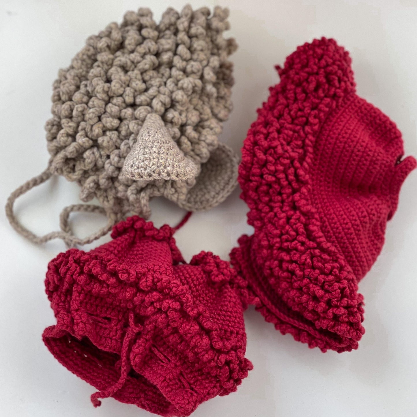 three crocheted hats sitting next to each other