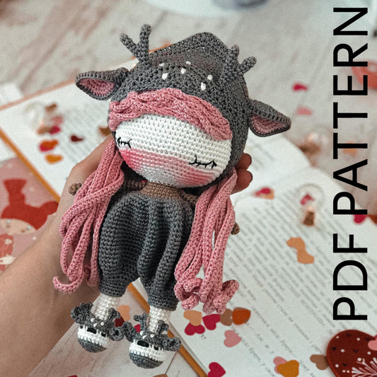 a person holding a stuffed animal on top of a table