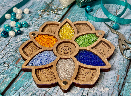 a wooden ornament with beads and a pair of scissors