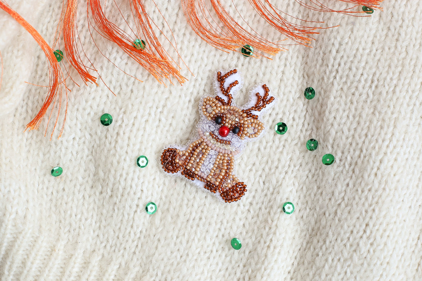 a close up of a sweater with a deer on it