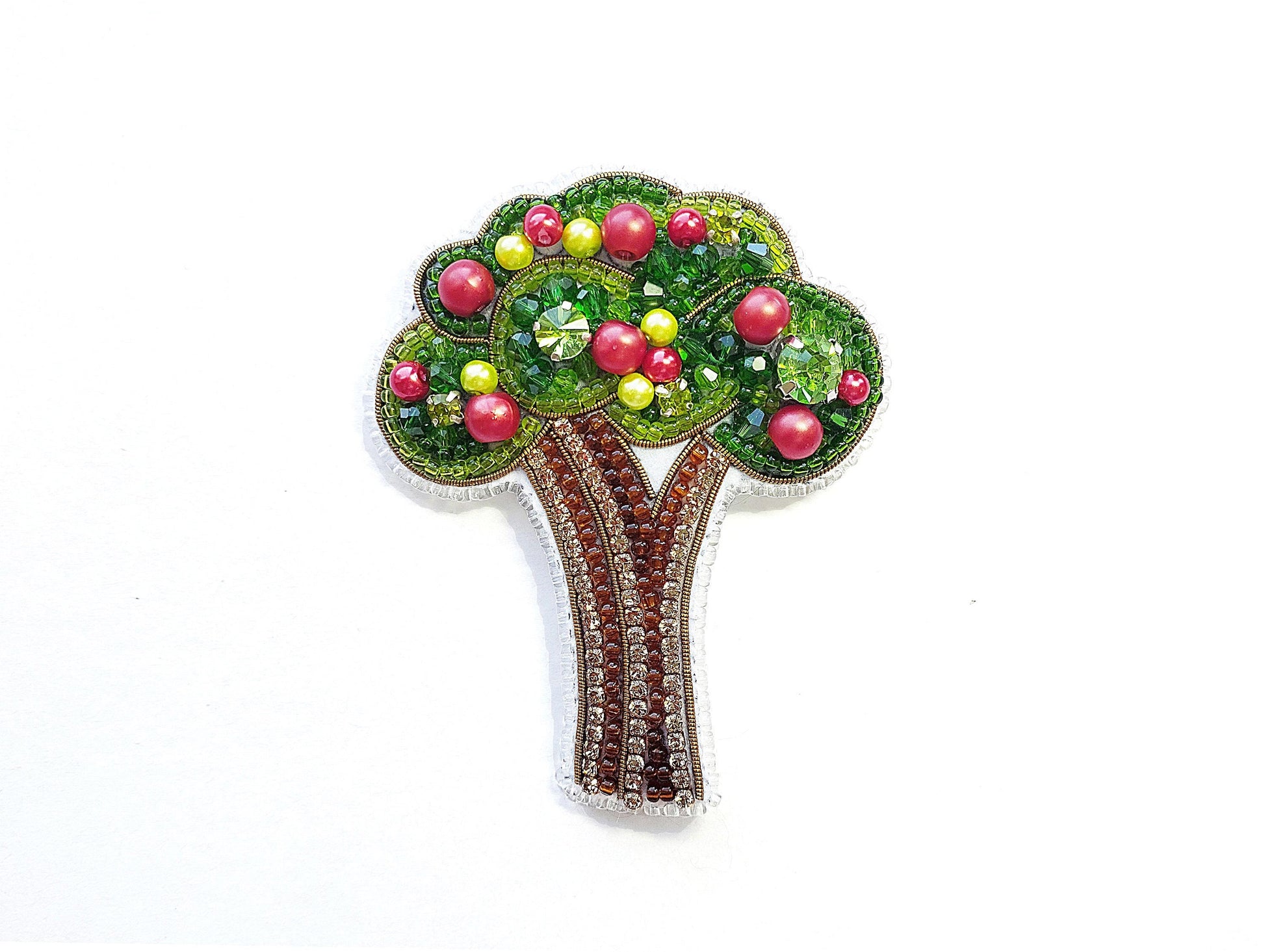 a brooch with a tree made of beads