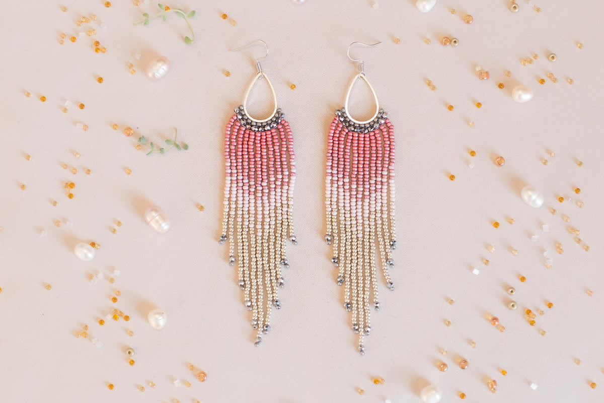a pair of red and white beaded earrings