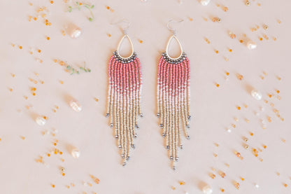 a pair of red and white beaded earrings