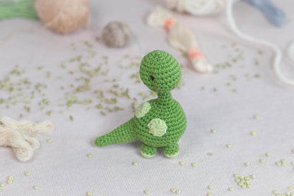 a green crocheted toy sitting on top of a table