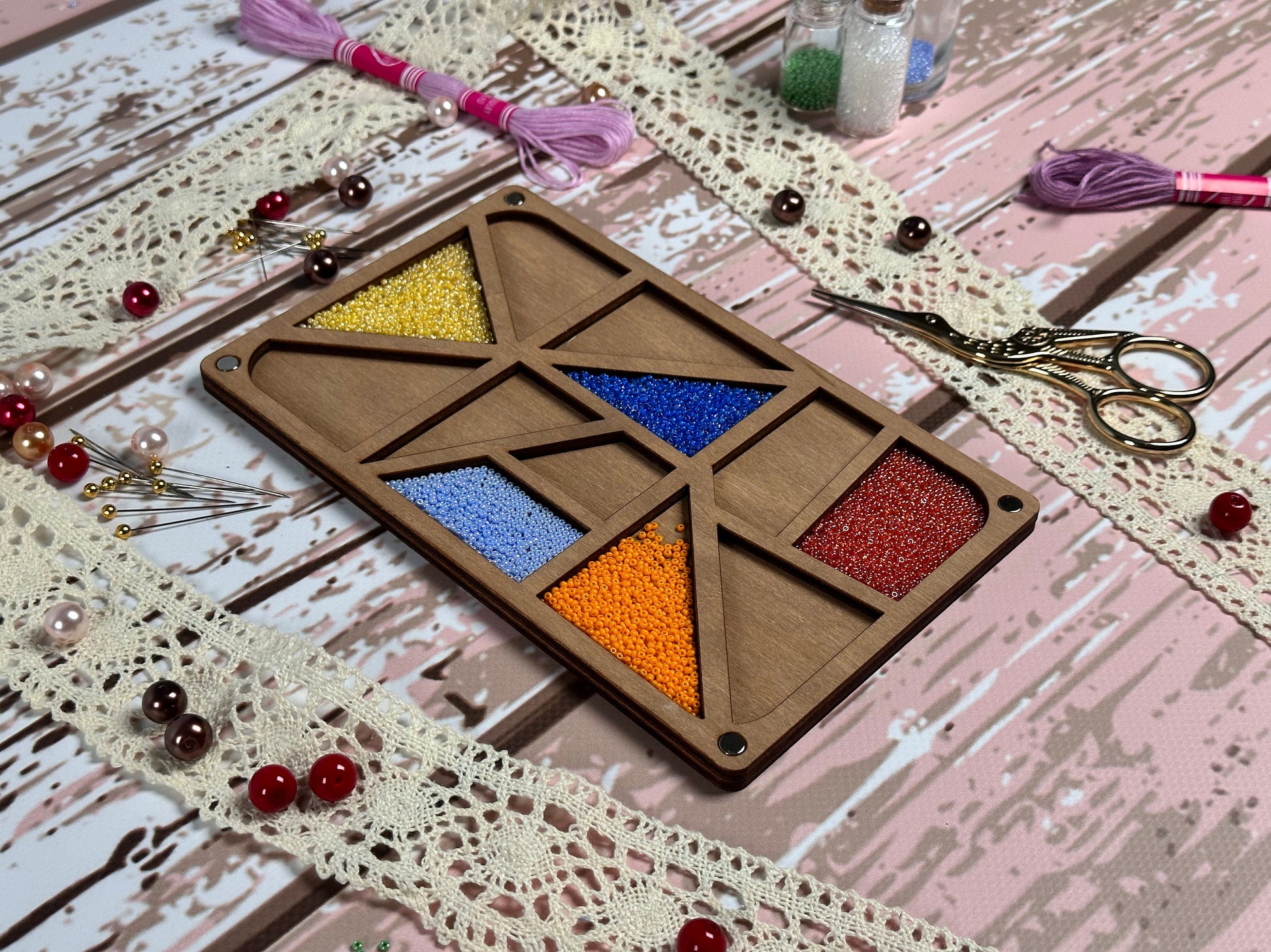 a table topped with crafting supplies like scissors and beads