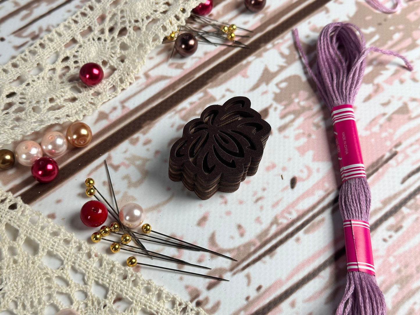 a close up of a piece of fabric next to a pair of knitting needles