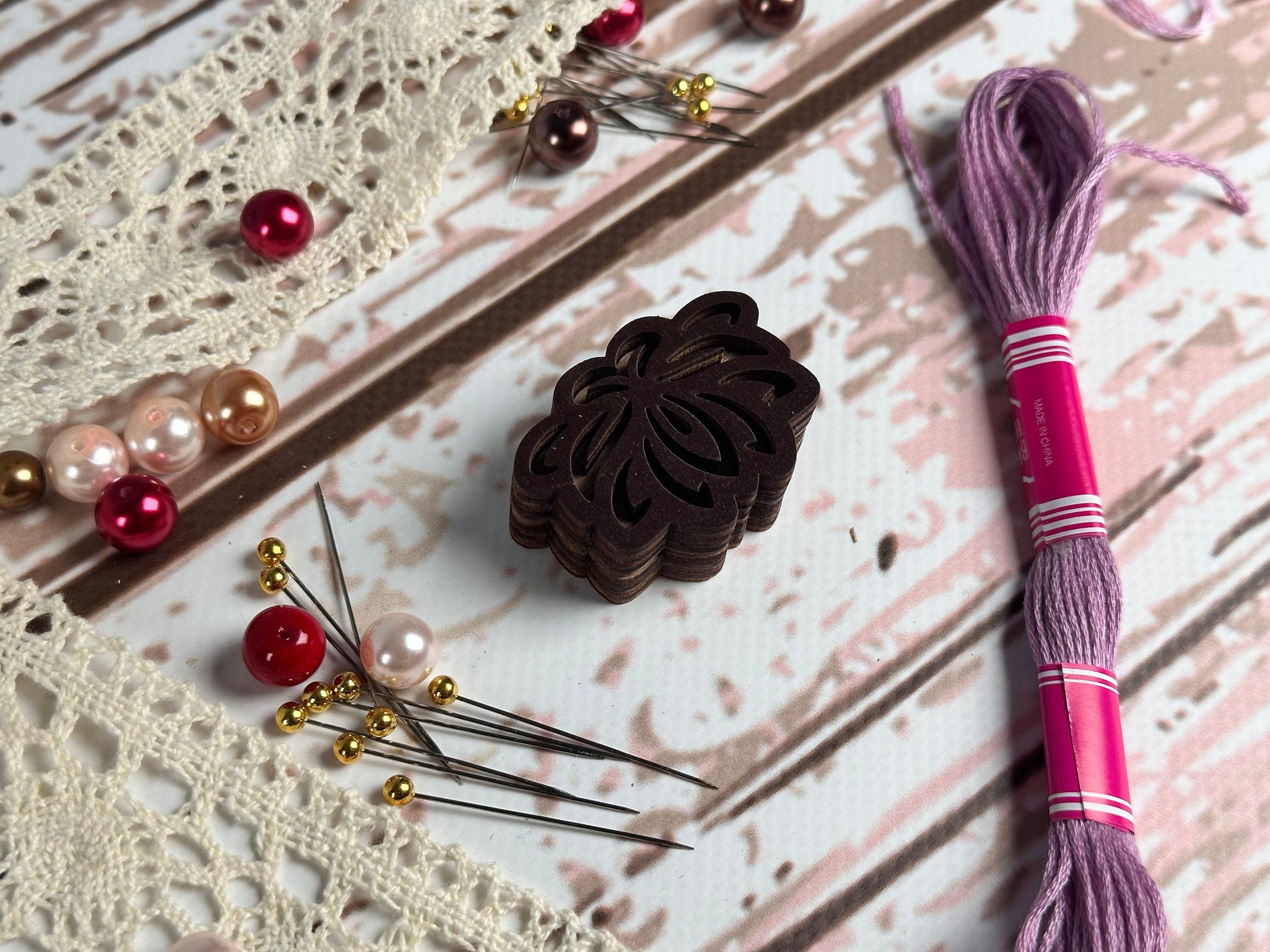 a close up of a piece of fabric next to a pair of knitting needles