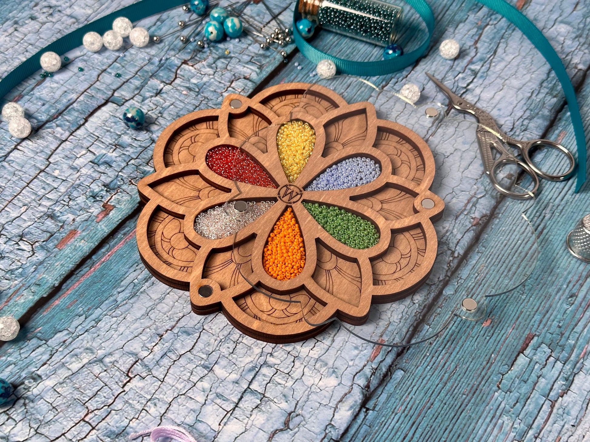 a wooden keychain with a flower design on it