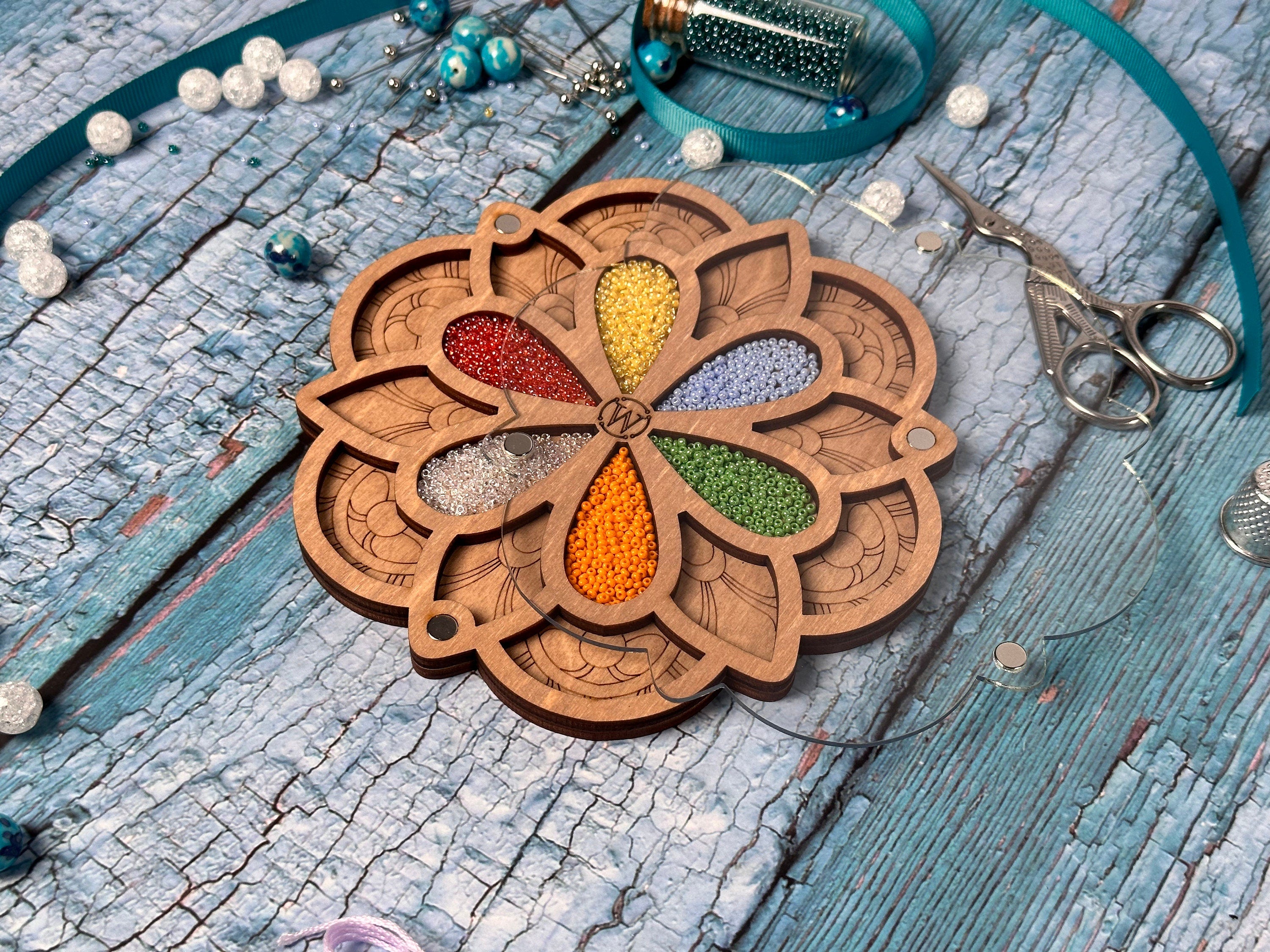 a wooden keychain with a flower design on it
