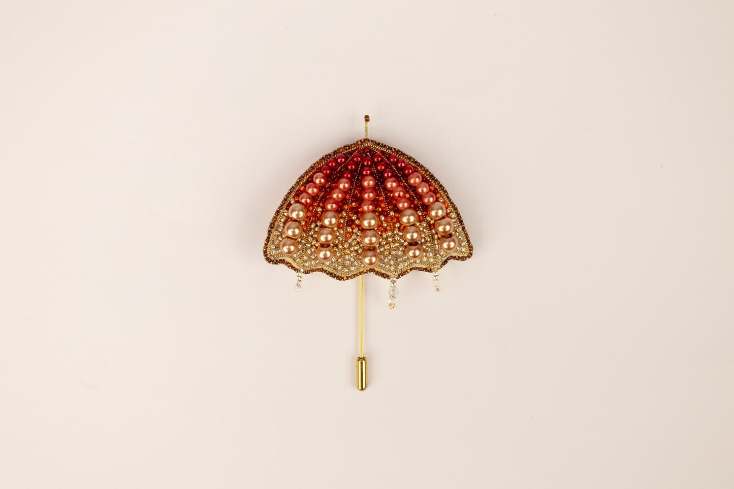 a red and gold umbrella hanging on a wall