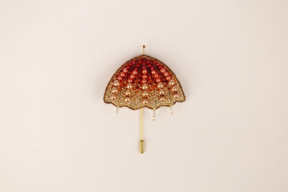 a red and gold umbrella hanging on a wall