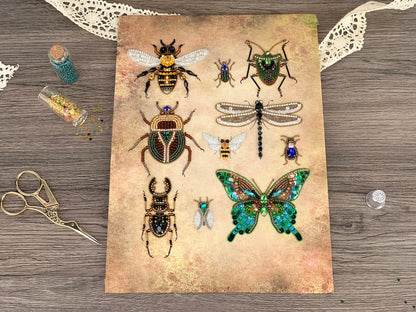 a collection of various insects, including a bee, a dragonfly, and a butterfly, arranged on a textured surface. There are also some small objects, such as a pair of scissors and a small glass bottle, scattered around the insects.