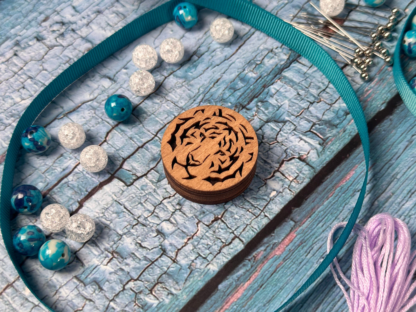 a wooden necklace with a tiger design on it