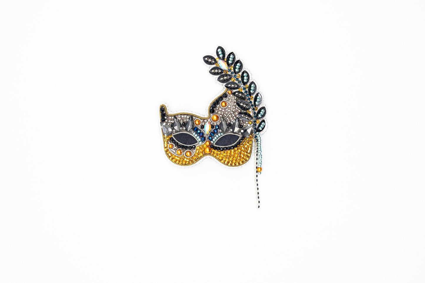 a masquerade mask hanging on a wall