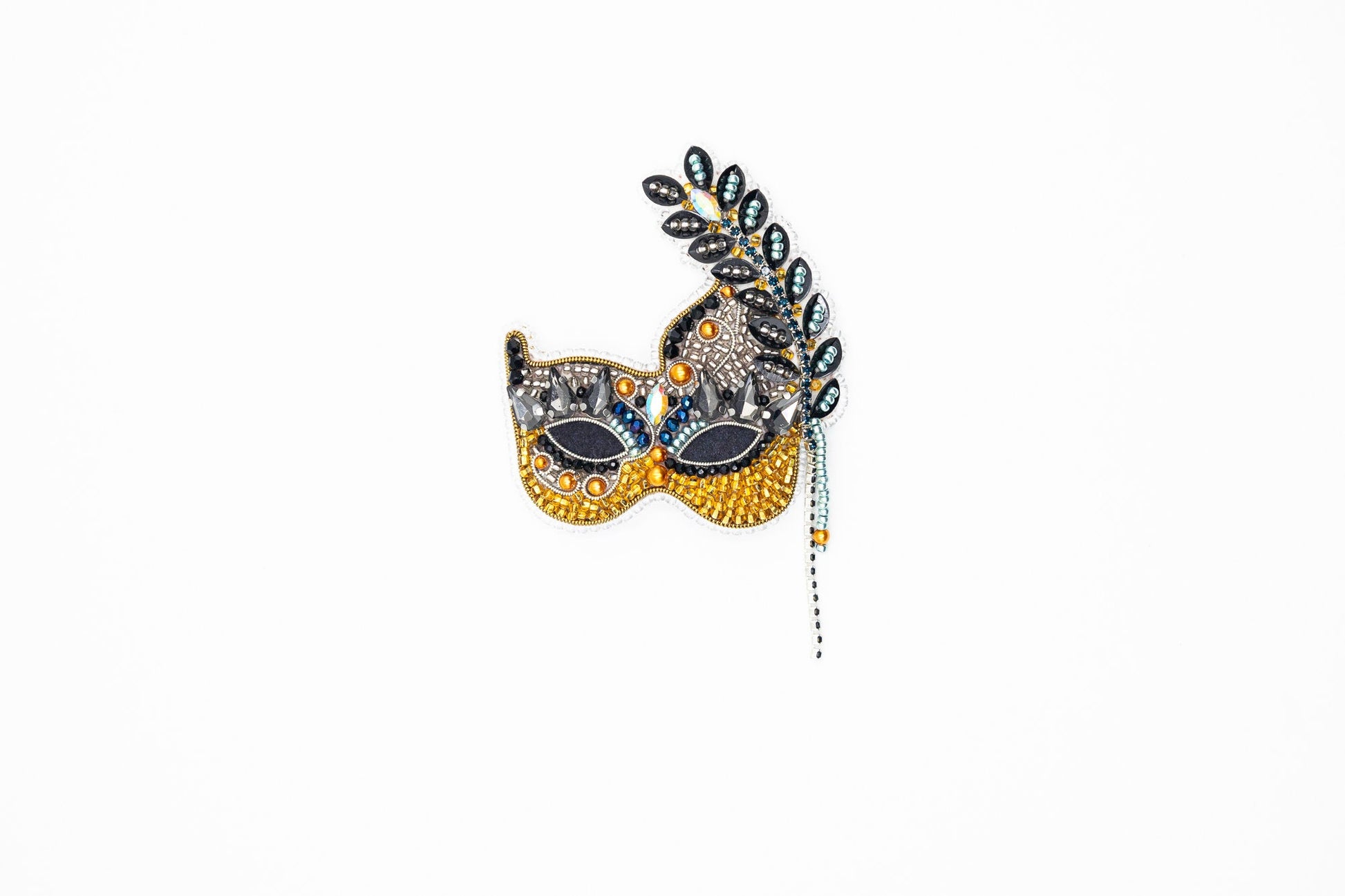 a masquerade mask hanging on a wall