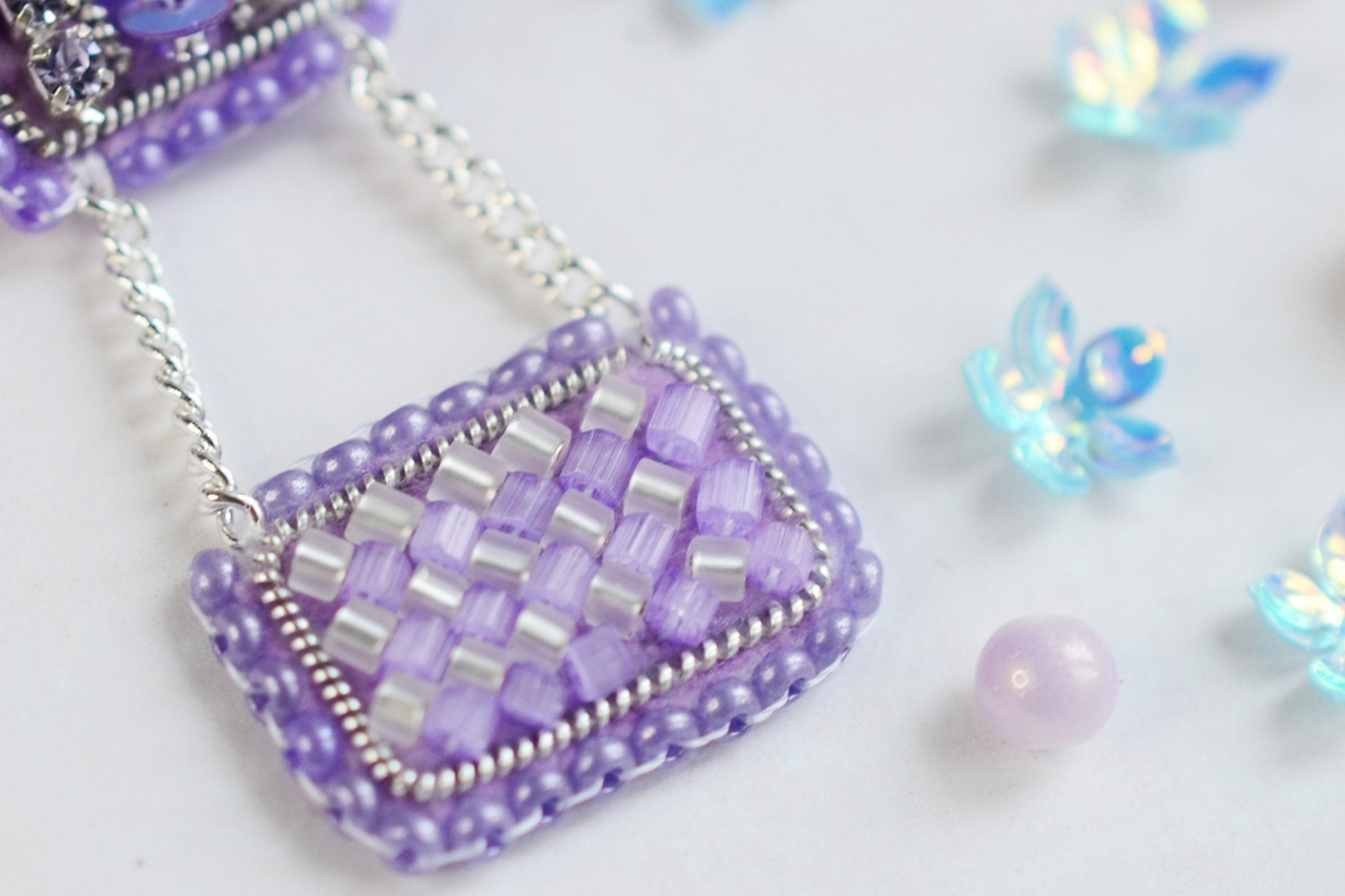 a close up of a beaded purse on a chain