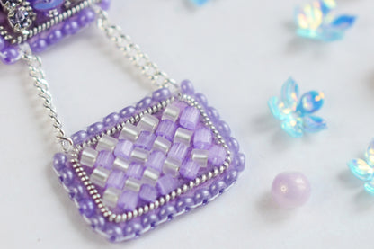 a close up of a beaded purse on a chain