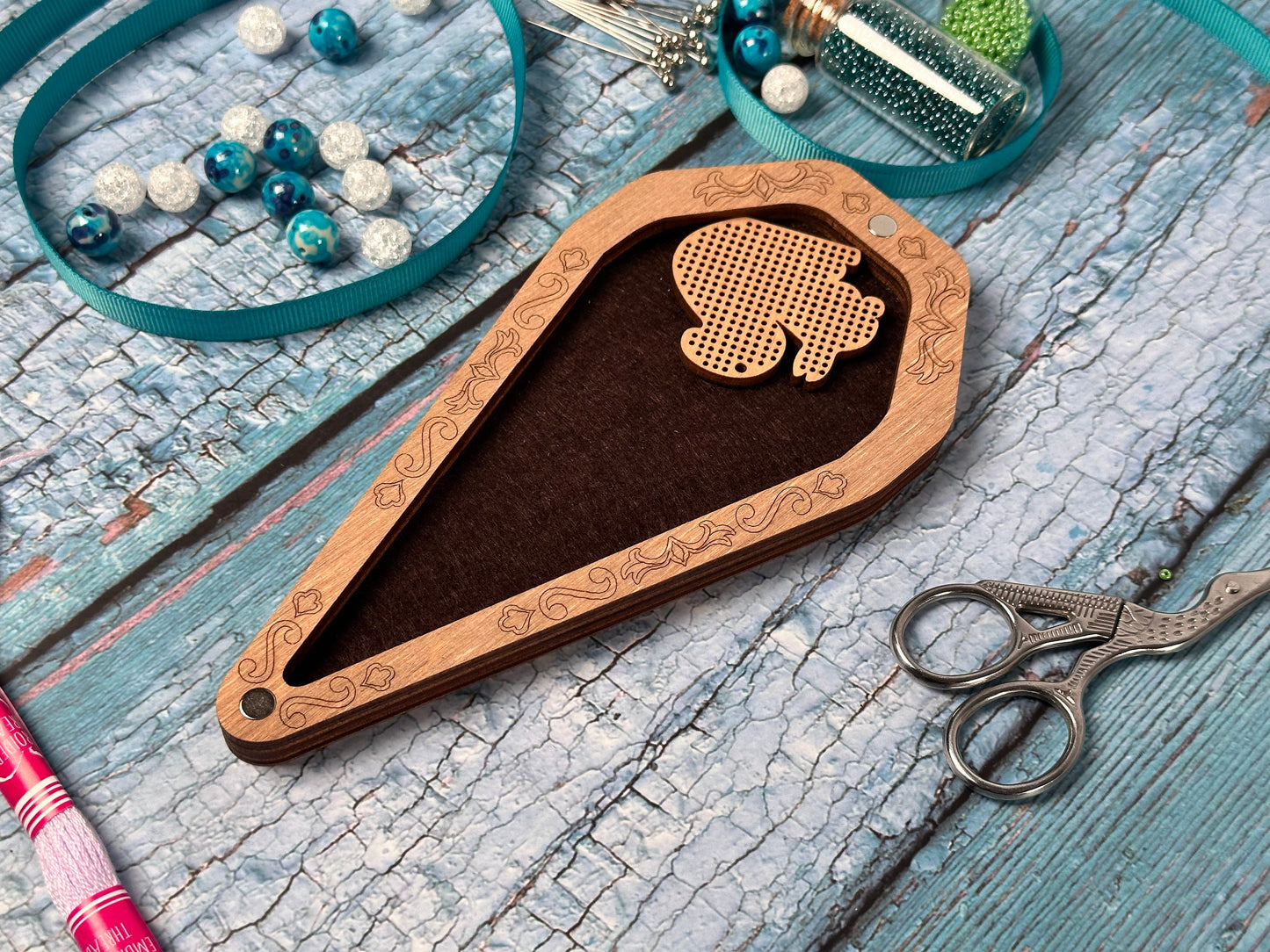 a pair of scissors and some beads on a table