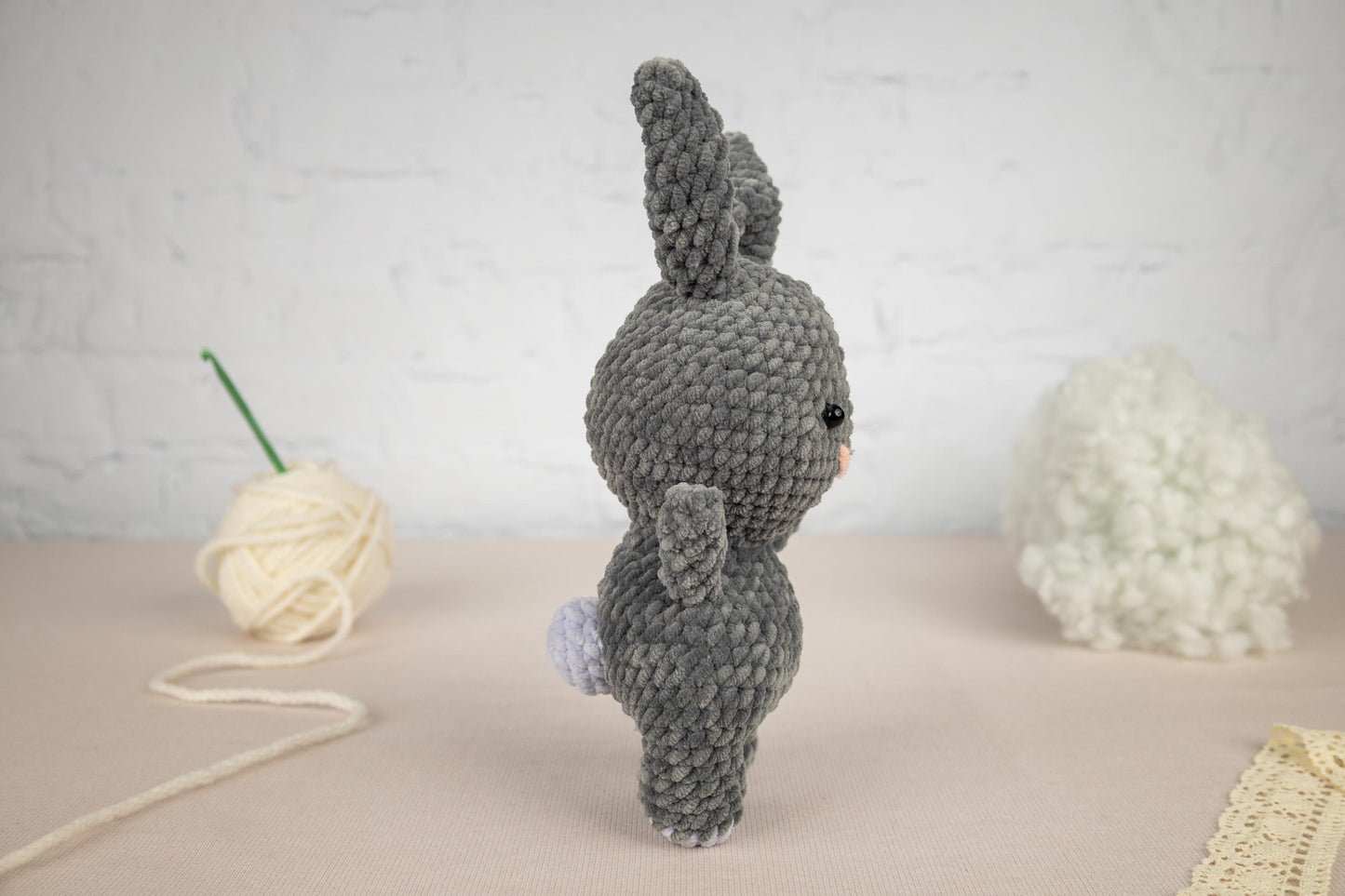 a crocheted stuffed animal next to a ball of yarn