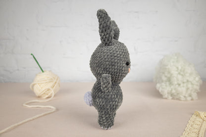 a crocheted stuffed animal next to a ball of yarn