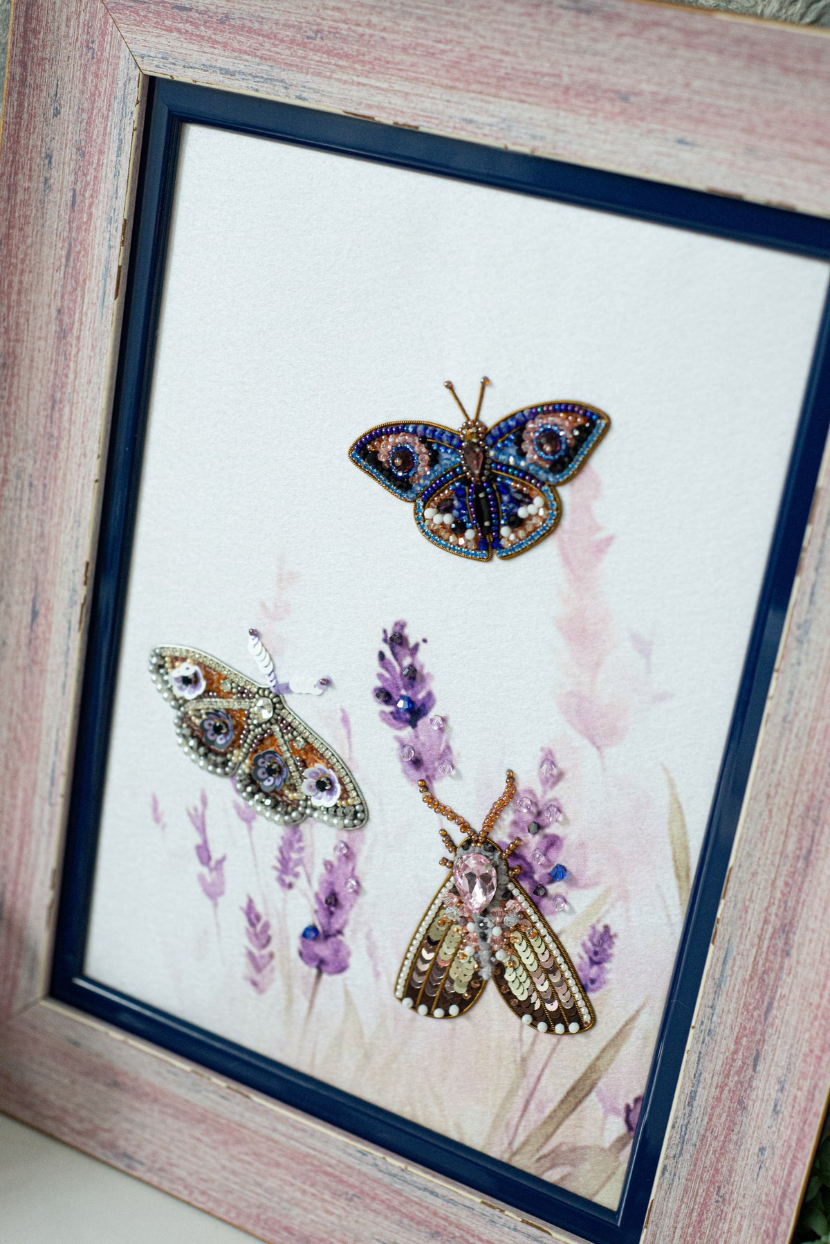 three butterflies, each with unique patterns and colors, set against a background of purple flowers.