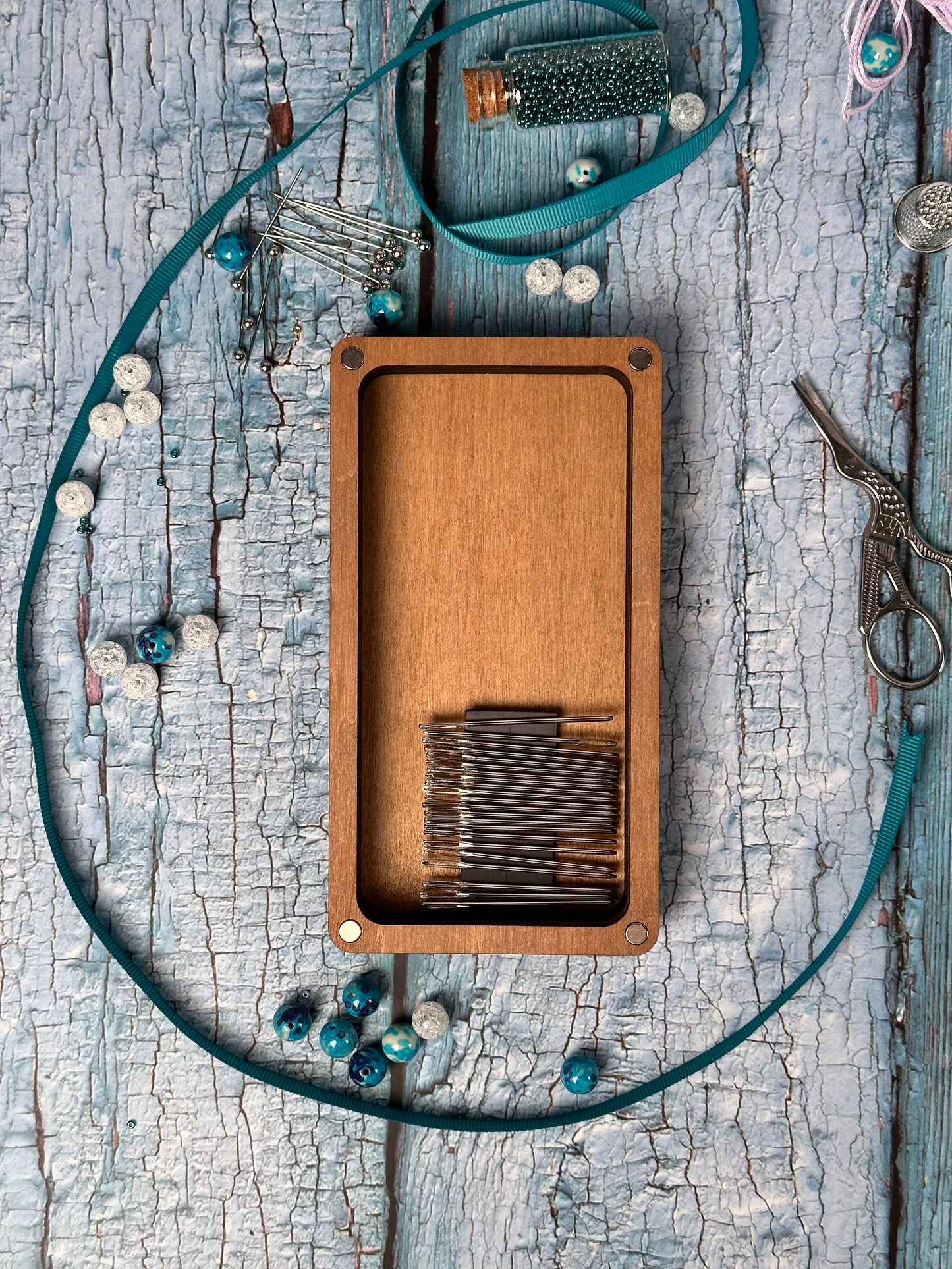 a wooden box with a string and a pair of scissors