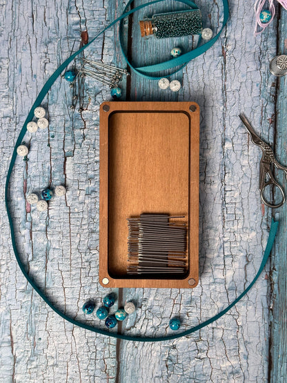 a wooden box with a string and a pair of scissors