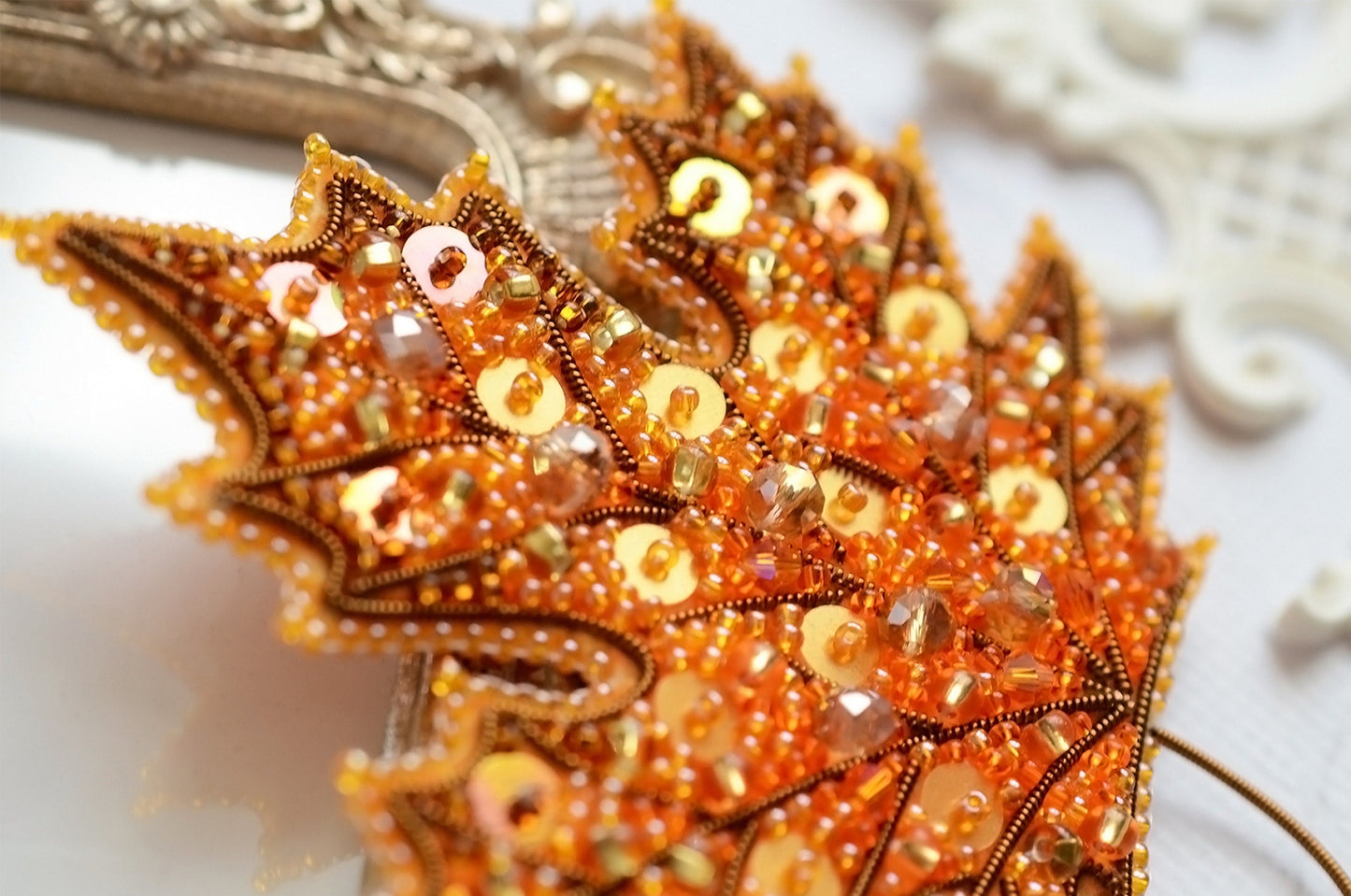 a close up of a brooch on a table