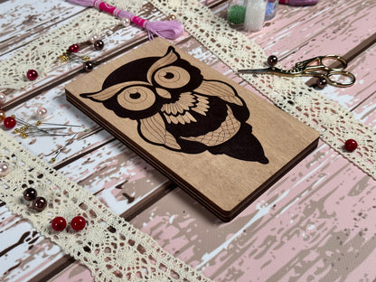 a small wooden box with a picture of an owl on it