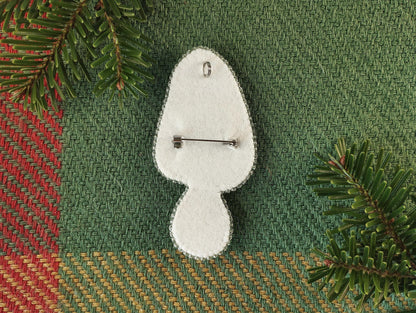 a white brooch pin sitting on top of a table