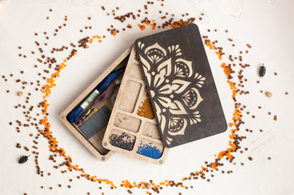 a couple of wooden boxes filled with crafting supplies