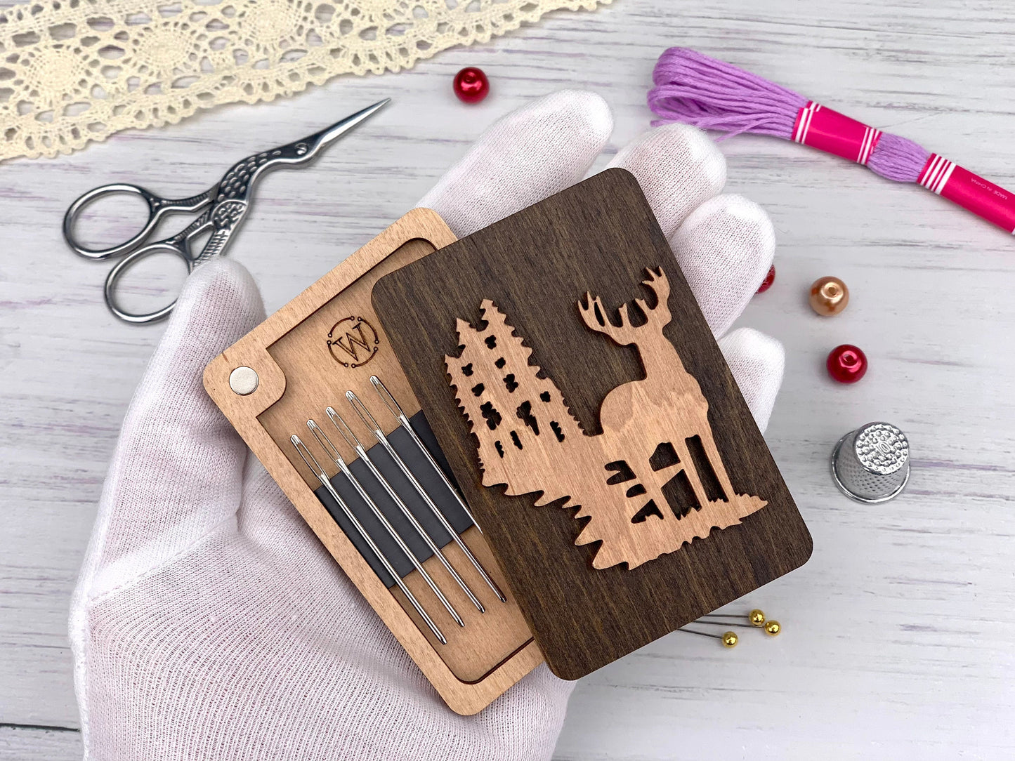 a wooden cutout of a deer with a forest scene