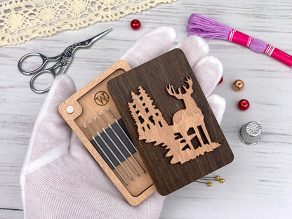 a wooden cutout of a deer with a forest scene