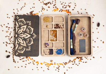 a wooden box filled with lots of crafting supplies