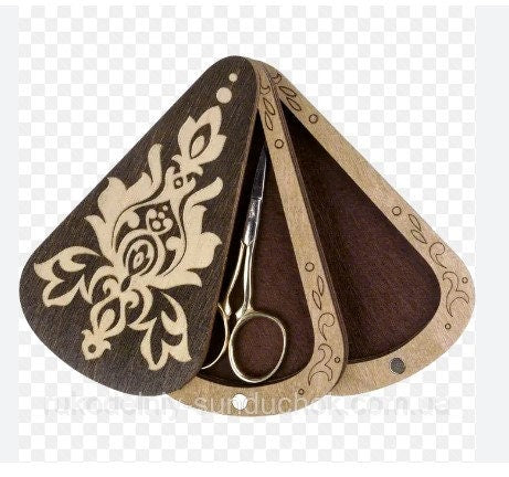 a pair of scissors sitting on top of a wooden holder