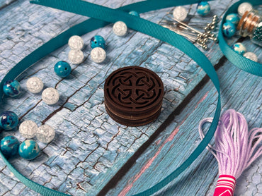 a close up of a piece of jewelry on a table