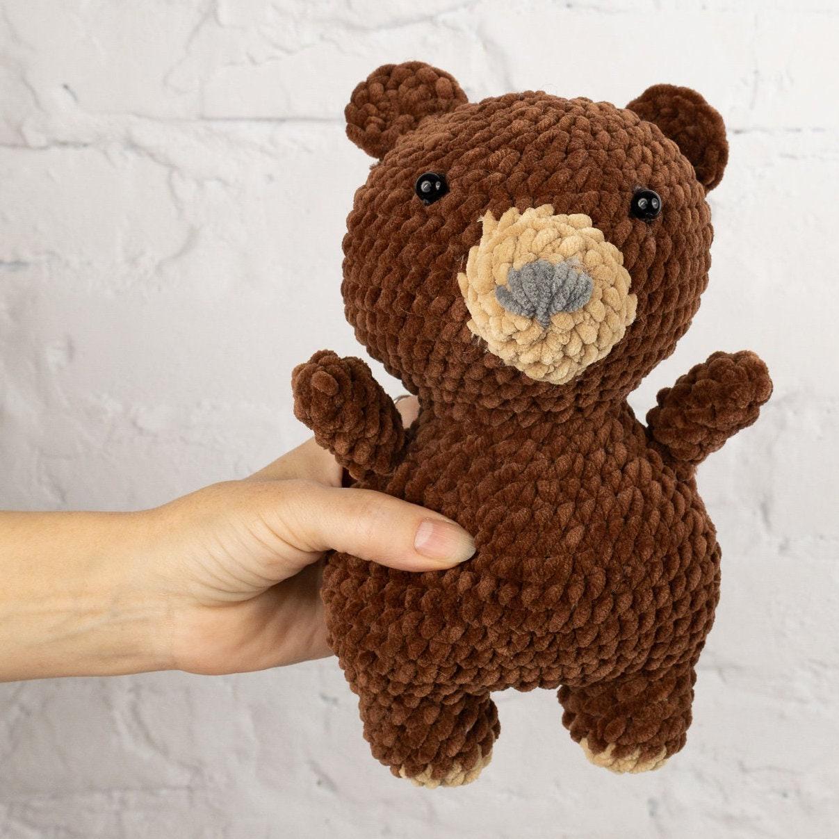 a crocheted brown teddy bear standing on its hind legs