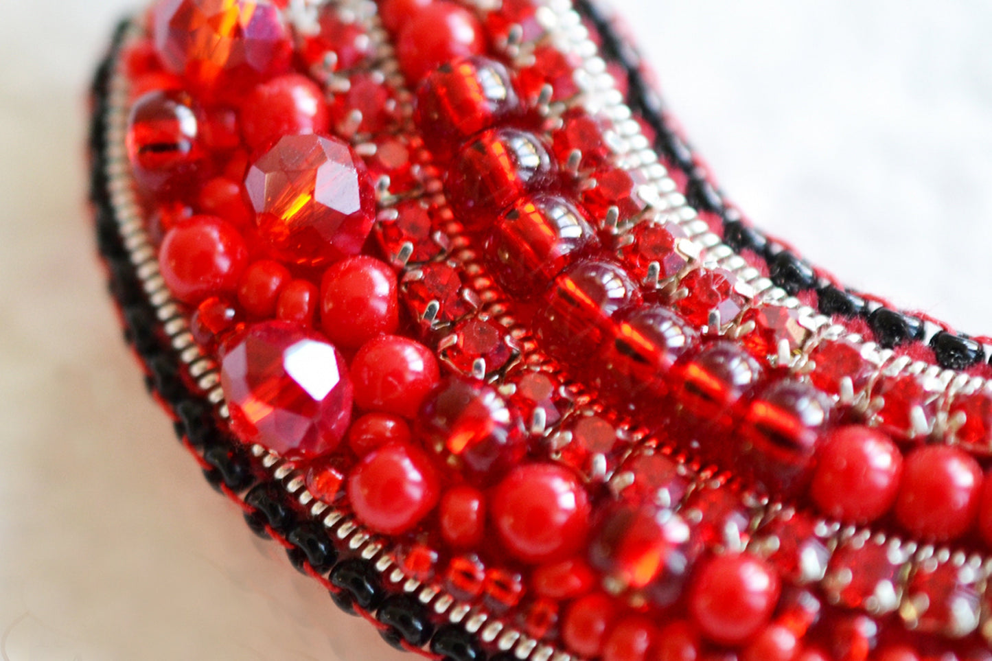 a close up of a red beaded purse