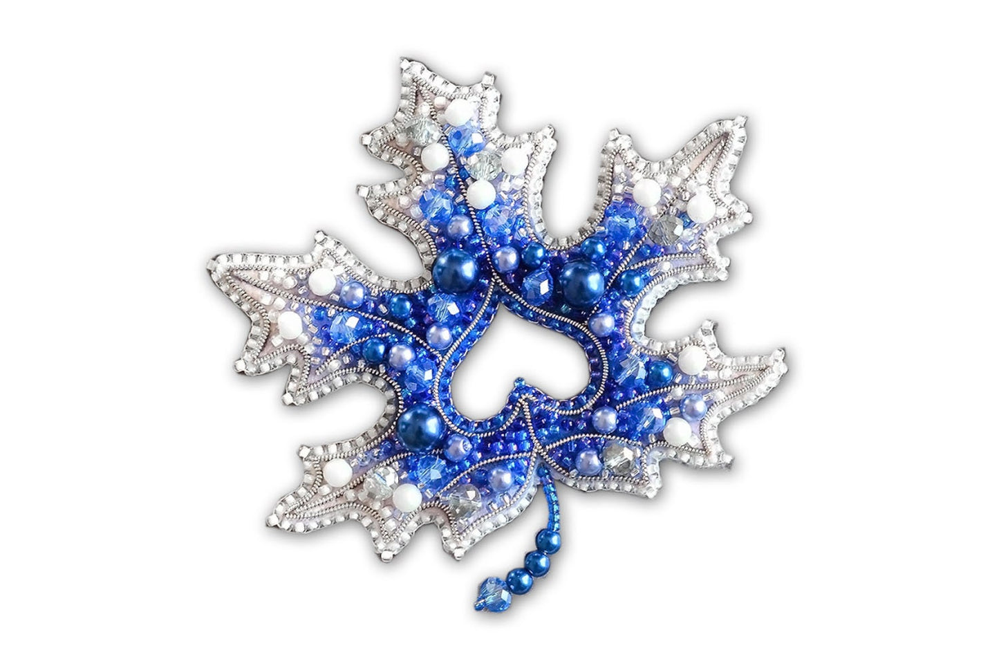 a blue and white brooch with beads on it