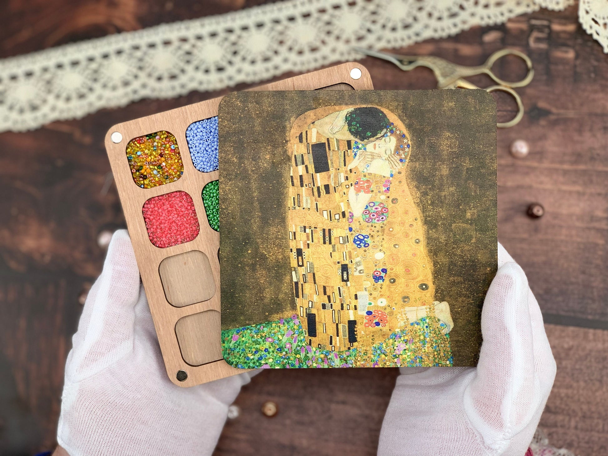 a person holding up a picture of a painting