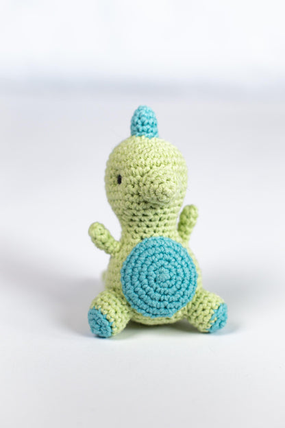 a crocheted stuffed animal sitting on a white surface