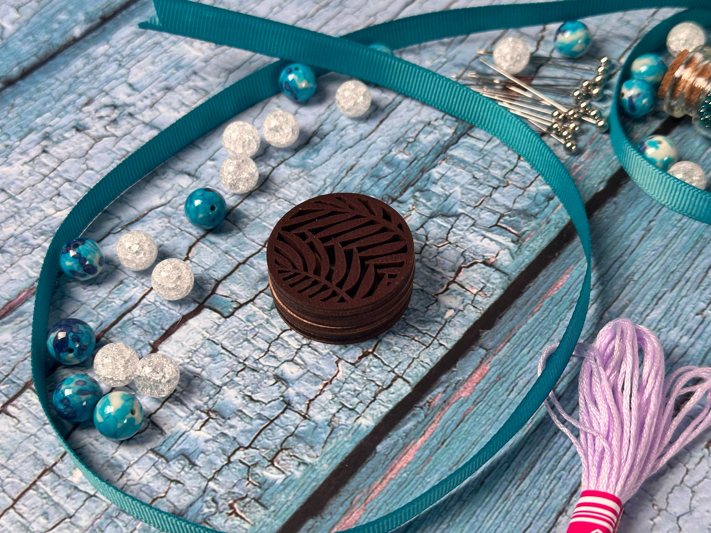 a necklace with a tassel on a wooden table