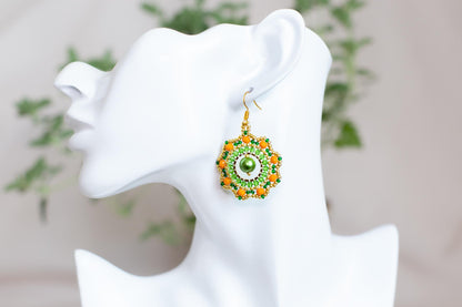 a close up of a pair of earrings on a mannequin head