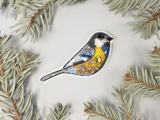 a blue bird sitting on top of a pine tree