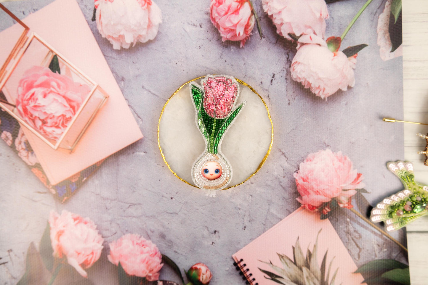 a table topped with pink flowers and pictures