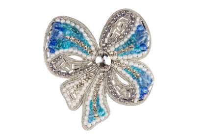 a brooch with blue and white beads