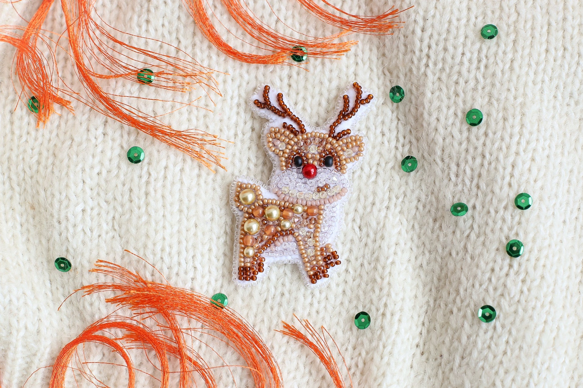 a close up of a sweater with a deer on it